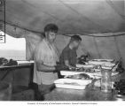 Vernon Brock and Dr. L. P. Schultz packing fish for shipment to the U. S. National Museum for taxonomic study, Bikini Atoll, 1947