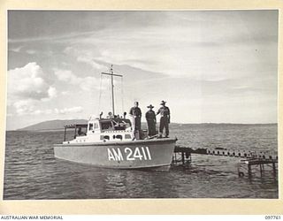 DALLMAN HARBOUR, NEW GUINEA. 1945-10-10. CORPORAL K. MANGAN (1), SERGEANT B.H. HACKETT (SKIPPER) (2), AND SERGEANT P. STUART (3), MEMBERS OF 42 LANDING CRAFT COMPANY, ON THEIR FIELD SECURITY BOAT, ..
