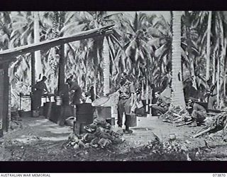 MADANG, NEW GUINEA. 1944-06-15. THE OTHER RANKS' KITCHEN AND STAFF AT HEADQUARTERS, 15TH INFANTRY BRIGADE. THE UNIT IS AT PRESENT LOCATED AT SIAR PLANTATION. LEFT TO RIGHT: SX6579 PRIVATE R. W. ..