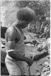 Portrait of man in t-shirt working with kofu shell money