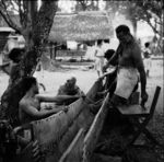 Lashing upper plank to hull of canoe