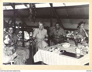 TOROKINA, BOUGAINVILLE, 1945-08-16. THE ENGLISH SINGER GRACIE FIELDS WITH MEMBERS OF THE AUSTRALIAN ARMY NURSING SERVICE ENJOYING A CUP OF TEA AT THE SISTERS' MESS, 2/1 GENERAL HOSPITAL DURING HER ..