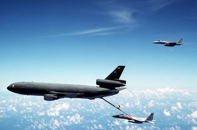 One F-15C Eagle aircraft from the 18th Tactical Fighter Wing holds position as another receives fuel from 22nd Air Refueling Wing KC-10A Extender aircraft during Exercise Giant Warrior '89