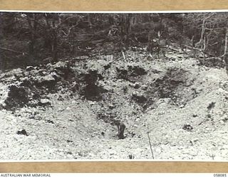 KAKAKOG AREA, NEW GUINEA, 1943-10-02. A HUGE CRATER MADE BY A HEAVY ALLIED BOMB