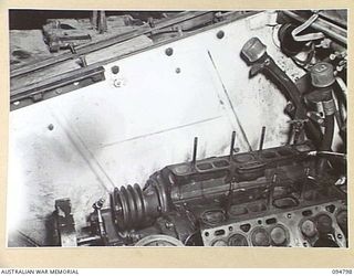 TOROKINA AREA, BOUGAINVILLE, 1945-08-07. THE ENGINE OF AN M24 GENERAL CHAFFEE LIGHT TANK. THE DARK LINE INDICATES THE HEIGHT TO WHICH THE WATER ROSE WHEN IT BECAME PARTIALLY SUBMERGED ON LEAVING ..
