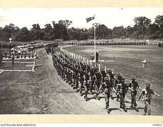 LAE, NEW GUINEA, 1944-03-08. GENERAL VIEW OF THE MARCH PAST OF HEADQUARTERS, 29TH INFANTRY BRIGADE AS MAJOR-GENERAL F.H. BERRYMAN, CBE, DSO, GENERAL OFFICER COMMANDING 2ND AUSTRALIAN CORPS TAKES ..