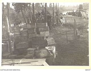 JABA RIVER AREA, BOUGAINVILLE, SOLOMON ISLANDS. 1944-12-18. PRIVATE LAUMAN, (1) ALONGSIDE A 52 LANDING CRAFT COMPANY BARGE LOADING MEDIUM MACHINE-GUNS AND MORTARS ON THE RIGHT BANK OF THE JABA ..
