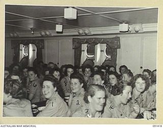 LAE, NEW GUINEA, 1945-05-07. AUSTRALIAN WOMEN'S ARMY SERVICE PERSONNEL HAVING BREAKFAST BEFORE DISEMBARKING BY LIGHTER FROM THE MV DUNTROON. THEY ARE PART OF A GROUP OF 342 AUSTRALIAN WOMEN'S ARMY ..