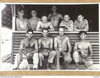 PORT MORESBY, NEW GUINEA. 1943-12-24. MEN OF THE 101ST AUSTRALIAN ARMY TROOPS COMPANY AND ELECTRICIANS OF THE 9TH AUSTRALIAN WORKS AND PARKS COMPANY WHO BUILT THE DARKROOM FOR THE AUSTRALIAN ..