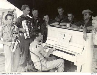 MILILAT, NEW GUINEA. 1944-08-23. MEMBERS OF THE "TASMANIACS", THE TASMANIAN LINES OF COMMUNICATION CONCERT PARTY, REHEARSING FOR THE EVENING SHOW. IDENTIFIED PERSONNEL ARE:- TX14842 STAFF SERGEANT ..
