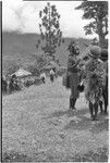 Church service in Tsembaga: decorated men prepare to dance at service held by Solomon Islander Anglican missionaries