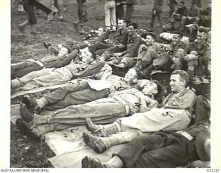 KILIGIA, NEW GUINEA. 1944-04-10. TROOPS AT HEADQUARTERS 5TH DIVISION AREA AWAITING COMMENCEMENT OF THE FILM "CHARLEY'S AUNT"