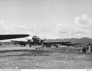 LAE, NEW GUINEA. 1943-10-11. LINE UP OF DOUGLAS TRANSPORT AIRCRAFT ON THE AIRSTRIP