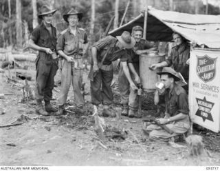 WEWAK AREA, NEW GUINEA, 1945-06-28. CORPORAL T.G. FERNINOUGH, SALVATION ARMY REPRESENTATIVE (4) SERVING COFFEE TO MEMBERS OF 2/8 INFANTRY BATTALION ON HILL 2. IDENTIFIED PERSONNEL ARE:- SERGEANT F. ..