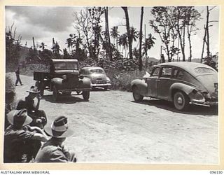 RABAUL, NEW BRITAIN, 1945-09-10. THE FIRST JAPANESE TRUCK DRIVEN BY A SOLDIER OF THE AUSTRALIAN OCCUPATION FORCE ARRIVING AT THE ASSEMBLY POINT, PASSING JAPANESE STAFF CARS CARRYING JAPANESE STAFF ..