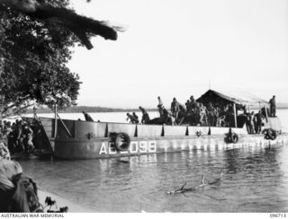 KAIRIRU ISLAND, NEW GUINEA. 1945-09-17. FOLLOWING THE SURRENDER ALL JAPANESE NAVAL PERSONNEL ON KAIRIRU ISLAND WERE TRANSFERRED TO MUSCHU ISLAND. SHOWN BARGE AND TRANSFERRED PERSONNEL ARRIVING AT ..