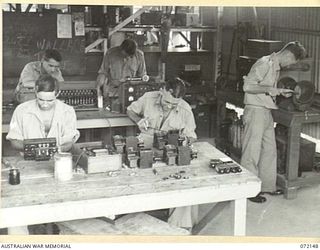 PORT MORESBY, NEW GUINEA. 1944-04-10. THE TELEPHONE REPAIR SECTION AT THE 11TH ADVANCED WORKSHOP, AUSTRALIAN ELECTRICAL AND MECHANICAL ENGINEERS. REPAIRS TO SIGNAL EQUIPMENT ARE ALSO CARRIED OUT IN ..