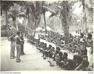 1943-10-08. NEW GUINEA. AT KAIAPIT. NATIVES WHO A WEEK PREVIOUSLY WERE CONTROLLED BY THE JAPANESE RECEIVE INSTRUCTIONS ON AUSTRALIAN METHODS OF WORKING FROM LT. IRELAND OF COLLAROY N.S.W. SGT. J. ..