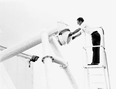 CPT Mel Fourroux, from the Air Force Air Weather Service, adjusts space eye of a new optical telescope. The telescope is the first of five observatories in the Solar Electro Optical Network (SEON) that will provide sun watch on a world-wide basis. (Substandard image)
