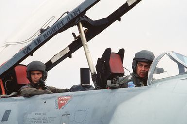 General (GEN) Jack I. Gregory, Commander-In-CHIEF, Pacific Air Forces, and First Lieutenant (1LT) Kenneth Hyvonen, 15th Air Base Wing, sit in the cockpit of a T-33 Shooting Star aircraft after piloting the plane during its final flight. The aircraft is b