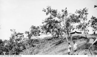 Brigade Headquarters, 73rd Anti-Aircraft Searchlight Battery operations room on a hill in the Port Moresby area. Lieutenant Colonel J. A. Robinson and Lieutenant L. M. Tosh are in the foreground