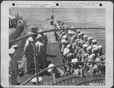 Los Negros, Admiralty Islands-The crew of the submarine which rescued flyers of two 13th AAF bombers from the 394th Bomb Squadron, 5th Bomb Group shot down over Yap Island in the Caroline Group, line up to hear a note of thanks from Colonel A.H. (U.S. Air Force Number 68145AC)