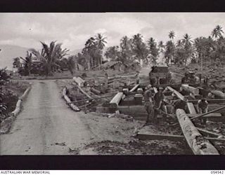 MILNE BAY, NEW GUINEA, 1943-07-12. ON ROUTE 3 OLD BRIDGE AND NEW BRIDGE ACROSS LAVIAM CREEK BEING CONSTRUCTED BY THE 21ST AUSTRALIAN ARMY FIELD COMPANY
