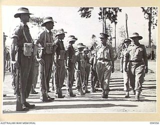 LAE AREA, NEW GUINEA, 1945-08-05. BRIGADIER P.S. MCGRATH, DEPUTY DIRECTOR OF SUPPLIES AND TRANSPORT (1) ACCOMPANIED BY SENIOR OFFICERS DURING AN INSPECTION OF NO. 73 PLATOON, 151 GENERAL TRANSPORT ..