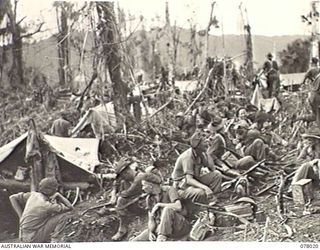 BOUGAINVILLE ISLAND. 1944-12-30. MEMBERS OF "D" COMPANY, 25TH INFANTRY BATTALION ASSEMBLED ON THE NORTH EAST SPUR WAITING FOR THE ORDER TO ATTACK JAPANESE POSITIONS IN THE PIATERAPAIA SECTOR