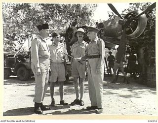 NEW GUINEA: GOVERNOR-GENERAL, LORD GOWRIE, VISITS NEW GUINEA. LORD GOWRIE INSPECTS AUSTRALIAN MANNED AIRCRAFT. PHOTOGRAPHED WITH HIM ARE SQUADRON LEADER W.T.M. BOLTON. SYDNEY F/O NORMAN FRASER, OF ..