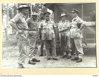 BOUGAINVILLE. 1945-03-26. GENERAL SIR THOMAS A. BLAMEY, COMMANDER-IN-CHIEF, ALLIED LAND FORCES, SOUTH WEST PACIFIC AREA (3), TALKING WITH A GROUP OF STAFF OFFICERS, DIVISIONAL AND BRIGADE ..