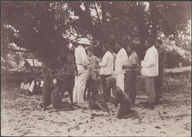 Bishop Wilson and Reverend Bollen speaking with local teachers, Maravovo, Solomon Islands, 1906 / J.W. Beattie