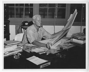 [Fleet Admiral Chester W. Nimitz Sits at Desk in Headquarters]