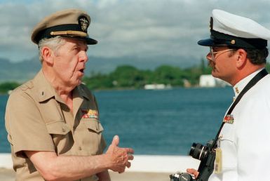 CWO Robert J. Peth, USN (Ret.), a survivor of the Japanese attack on Pearl Harbor, speaks with MASTER CHIEF Photographer's Mate Mitchell following ceremonies commemorating the 50th anniversary of the event