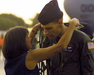 SENIOR AIRMAN (SRA) Curtis Towne, USAF, a crew member from the USN EP-3 Aries II aircraft involved in the March 31st accident with a Chinese F-8 aircraft, receives a lay as he is welcomed at Hickam AFB, Hawaii. The crew arrived at Hickam AFB, HI from Anderson AB, Guam on board an USAF C-17 Globemaster III aircraft, as part of Operation VALIANT RETURN. The EP-3 crew members were detained in China for 17 days prior to being released