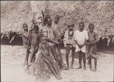 A man with a group of boys at Kombe on Florida Island, Solomon Islands, 1906 / J.W. Beattie