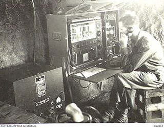 DUMPU, NEW GUINEA. 1944-01-11. VX8245 LIEUTENANT E. R. BLACKFORD OF THE 7TH DIVISION SIGNALS OPERATING A 188 W/T TRANSMITTER