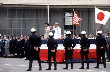 Hawaii Gov. George Ariyoshi (left), the Prime Minister of Japan, Zenko Suzuki (center) and Pacific Fleet Commander, ADM Sylvester R. Foley, stand on the reviewing stand during an aloha ceremony prior to the Prime Minister's departure after a visit