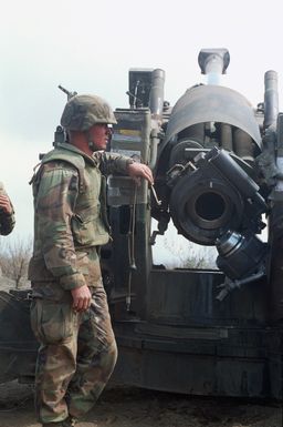 A marine from Bravo Battery, 1ST Battalion, 12th Marines, 3rd Marine Regiment awaits the next stage of fire with the breach open on a M198 155mm Towed Howitzer during a combined arms live fire exercise. The M198 is constructed of aluminum and steel, and is air transportable by CH-53E helicopter and C-130 or larger fixed-wing aircraft. Maximum effective range with conventional ammunition is 22,400 meters (13.92 miles) and with a rocket-assisted projectile, 30,000 meters (18.64 miles)