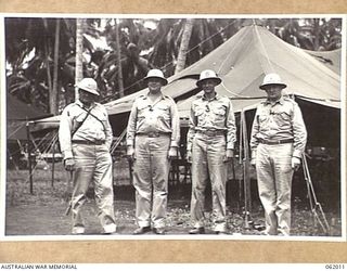 DREGER HARBOUR, NEW GUINEA. 1943-12-05. FOUR OFFICERS OF HEADQUARTERS, UNITED STATES BASE "F" AND THE 22ND PORT HEADQUARTERS, UNITED STATES ARMY SERVICES OF SUPPLY. LEFT TO RIGHT: COLONEL HARRY ..