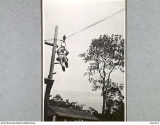 THORPVILLE, NEW GUINEA. 1943-12-07. QX9080 CORPORAL G. A. MONTAGUE EXERCISING ON THE "FLYING FOX" AT THE OPEN AIR GYMNASIUM OF THE PHYSIOTHERAPY SECTION 113TH AUSTRALIAN CONVALESCENT DEPOT