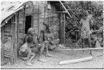 Men and boys in front of a house