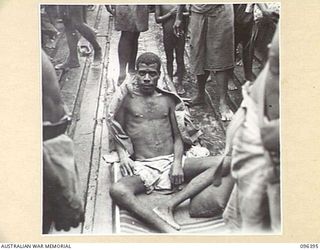 MUSCHU ISLAND, NEW GUINEA, 1945-09-11. A NATIVE, SERIOUSLY ILL, ON A MAKE-SHIFT STRETCHER. FOLLOWING THE SURRENDER OF THE JAPANESE, THE ISLAND NATIVES ARE BEING EVACUATED TO NEW GUINEA FOR ..