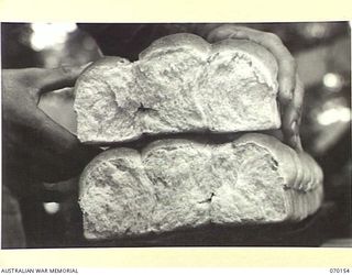 DUMPU, NEW GUINEA. 1944-02-05. THIS PICTURE INDICATES THE FINE TEXTURE OF ROLLS PRODUCED BY MEN OF THE 24TH INFANTRY BATTALION, AST THE 15TH INFANTRY BRIGADE BAKERY. THE RECIPE CONTAINS 6% WHEAT ..