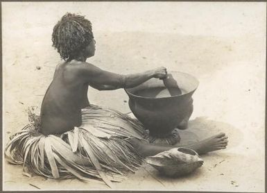 Mailu Island types [woman seated on the sand with a pot and a large shell] Frank Hurley