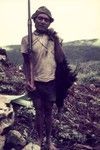 Hunter with his shotgun and a cassowary he has killed