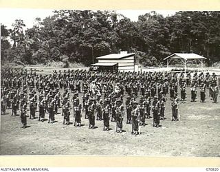 LAE, NEW GUINEA, 1944-03-08. THE INSPECTION OF THE 47TH INFANTRY BATTALION BY VX20308 MAJOR-GENERAL F.H. BERRYMAN, CBE, DSO, GENERAL OFFICER COMMANDING 2ND AUSTRALIAN CORPS, ACCOMPANIED BY NX94 ..