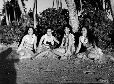 [Portrait of four Pacific Island women in grass skirts]