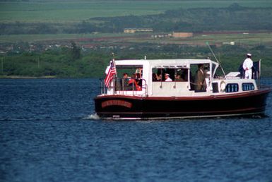 The barge of ADM Charles R. Larson, commander in chief, U.S. Pacific Command, transports President George Bush and Mrs. Bush toward the pier following their visit to the USS ARIZONA MEMORIAL. The president will present a speech as part of an observance commemorating the 50th anniversary of the Japanese attack on Pearl Harbor