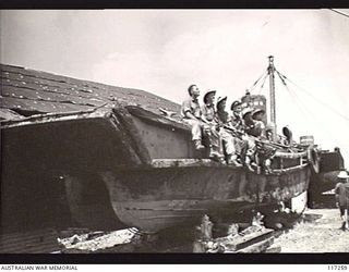 NAURU ISLAND. 1945-09-14. TROOPS OF THE 31/51ST INFANTRY BATTALION RELAXING ON A BEACHED JAPANESE BARGE DURING ONE OF THEIR STAND DOWN PERIODS